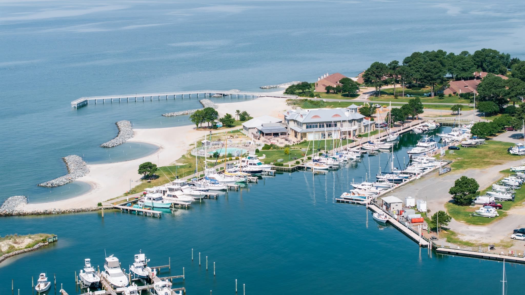 Aerial view of Windmill Point marina, docks, beach, and Chesapeake Bay shoreline in Virginia